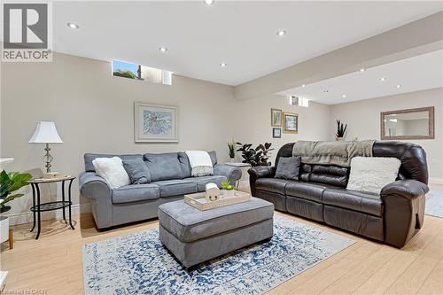 Spacious living area featuring light wood-finish flooring, recessed lighting, and neutral wall tones - 350 Doon Valley Drive Unit# 6D, Kitchener, ON - Indoor Photo Showing Living Room