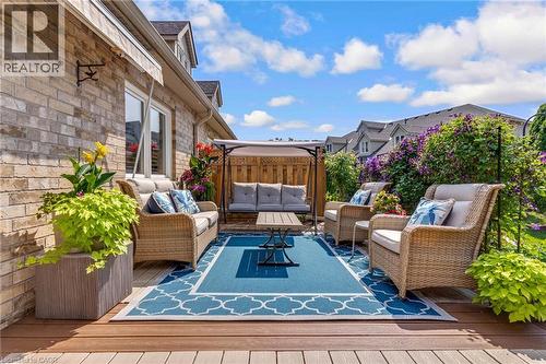 Expansive outdoor composite deck with a blue and white geometric area rug - 350 Doon Valley Drive Unit# 6D, Kitchener, ON - Outdoor With Deck Patio Veranda