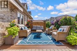 Expansive outdoor composite deck with a blue and white geometric area rug - 