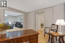 Open concept living area featuring recessed lighting, light wood-finish flooring, and light gray walls - 