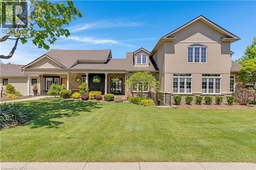 Expansive property featuring a meticulously manicured lawn, a covered front entry with columns, and a stone facade - 350 Doon Valley Drive Unit# 6D, Kitchener, ON - Outdoor With Deck Patio Veranda
