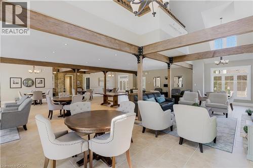 Spacious communal area featuring exposed wood-finish beams, vaulted ceilings, and light tile flooring - 350 Doon Valley Drive Unit# 6D, Kitchener, ON - Indoor
