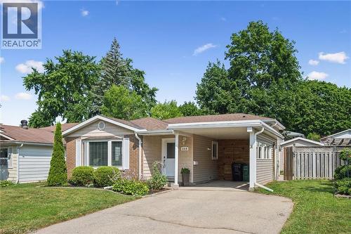 Single-story residence featuring a carport, brick and siding exterior, and a paved driveway - 659 Glen Forrest Boulevard, Waterloo, ON - Outdoor With Facade