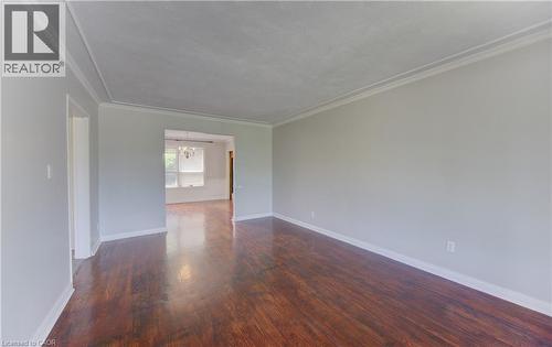 Spacious interior room featuring rich hardwood flooring, light gray walls, and crown molding - 139 Trafalgar Avenue, Kitchener, ON - Indoor Photo Showing Other Room