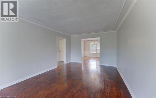 Hardwood flooring extending through an arched entryway - 139 Trafalgar Avenue, Kitchener, ON - Indoor Photo Showing Other Room