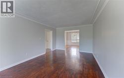 Hardwood flooring extending through an arched entryway - 
