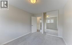 Bedroom featuring light gray carpeting and neutral wall paint - 