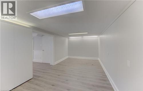 Spacious interior room that can double as another 4th bedroom, Den or Office featuring light wood-finish flooring, white walls, and bright overhead lighting - 139 Trafalgar Avenue, Kitchener, ON - Indoor Photo Showing Other Room