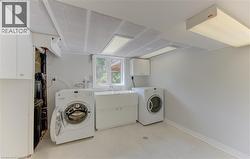 Dedicated laundry room featuring light-toned flooring, a utility sink, and a window - 