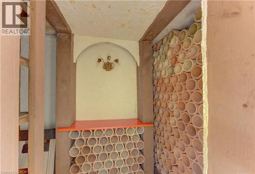 Niche that can be used as your own personal wine storage with arched top, integrated light fixture, and orange shelf - 139 Trafalgar Avenue, Kitchener, ON - Indoor Photo Showing Other Room