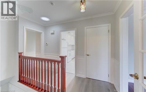 Hallway featuring wood-finish flooring, white paneling, and crown molding - 139 Trafalgar Avenue, Kitchener, ON - Indoor Photo Showing Other Room