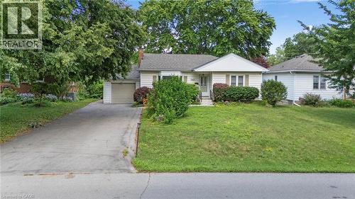 Single-story residence featuring light-colored siding, an attached garage, and a concrete driveway - 1063 Joan Drive, Burlington, ON - Outdoor