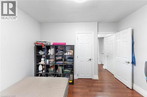 Room with wood-finish flooring, crisp white walls, and bright white trim - 1063 Joan Drive, Burlington, ON - Indoor