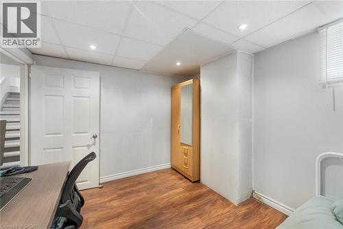 Room with wood-finish flooring, light grey walls, and a white paneled door - 1063 Joan Drive, Burlington, ON - Indoor