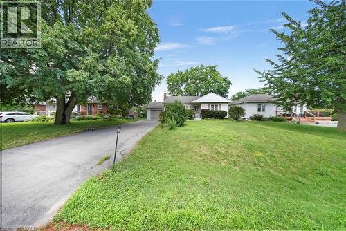 Ranch-style residence featuring a white exterior and a gabled roofline - 1063 Joan Drive, Burlington, ON - Outdoor
