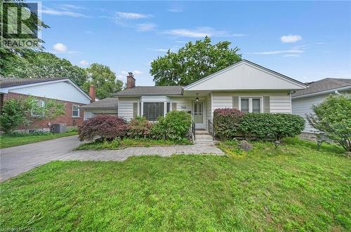 Single-story residence featuring light-colored siding and a contrasting dark roof - 1063 Joan Drive, Burlington, ON - Outdoor