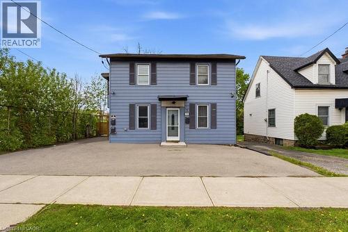 Two-story blue siding exterior with dark shutters, white trim windows, and a covered entry - 773 Lawrence Road, Hamilton, ON - Outdoor
