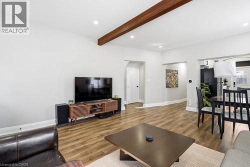 Spacious living area featuring wood-finish flooring, recessed lighting, and a prominent exposed wood beam - 773 Lawrence Road, Hamilton, ON - Indoor Photo Showing Living Room