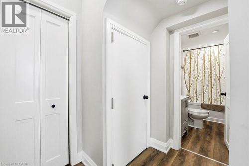 Hallway with wood-finish flooring, white trim, and white doors - 773 Lawrence Road, Hamilton, ON - Indoor