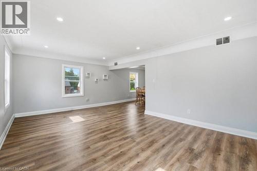 Spacious interior featuring wood-finish flooring, recessed lighting, and white baseboards - 773 Lawrence Road, Hamilton, ON - Indoor Photo Showing Other Room