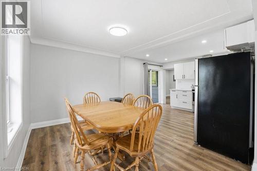 Spacious dining area featuring wood-finish flooring, light gray walls, and crown molding - 773 Lawrence Road, Hamilton, ON - Indoor Photo Showing Dining Room