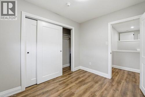 Room featuring wood-finish flooring, light gray wall paint, and white baseboards - 773 Lawrence Road, Hamilton, ON - Indoor Photo Showing Other Room