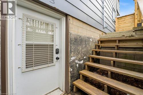 White exterior door with integrated blinds and a digital keypad lock - 773 Lawrence Road, Hamilton, ON - Outdoor With Exterior