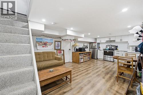 Open-concept living space featuring wood-finish flooring, recessed lighting, and a modern kitchen - 773 Lawrence Road, Hamilton, ON - Indoor