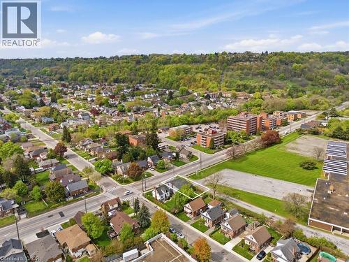 Aerial perspective showcasing a residential neighborhood with a tree-lined backdrop and multiple roadways - 773 Lawrence Road, Hamilton, ON - Outdoor With View