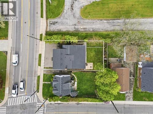 Overhead property view featuring a dark shingle roof, a rectangular grassy yard, and a paved driveway - 773 Lawrence Road, Hamilton, ON - Outdoor With View