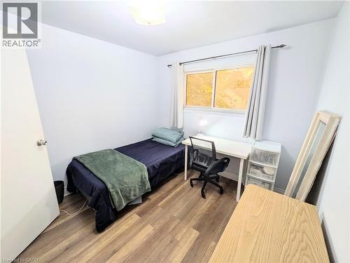 Room featuring wood-finish flooring, a bright window, and neutral wall tones - 22 Riverdale Drive Unit# 1, Hamilton, ON - Indoor Photo Showing Bedroom