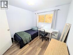 Room featuring wood-finish flooring, a bright window, and neutral wall tones - 