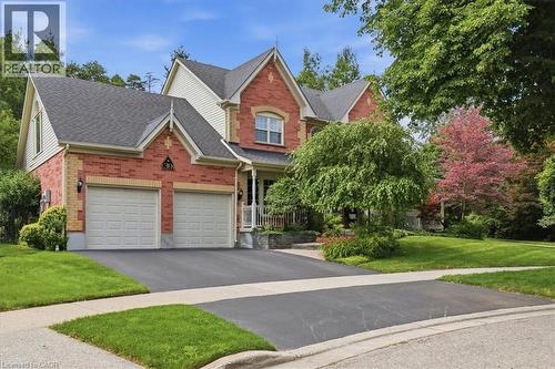 Brick and siding exterior featuring a multi-gabled roofline and a two-car garage - 39 Everwood Run, Kitchener, ON - Outdoor