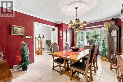 Dining area featuring tiled flooring, crown molding, and a bay window - 39 Everwood Run, Kitchener, ON - Indoor Photo Showing Dining Room