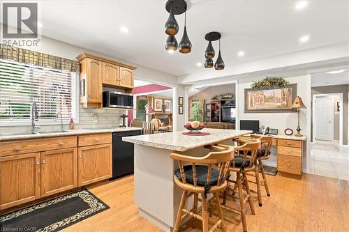 Kitchen featuring wood cabinetry, stainless steel sink, subway tile backsplash, and recessed lighting - 39 Everwood Run, Kitchener, ON - Indoor Photo Showing Kitchen With Double Sink