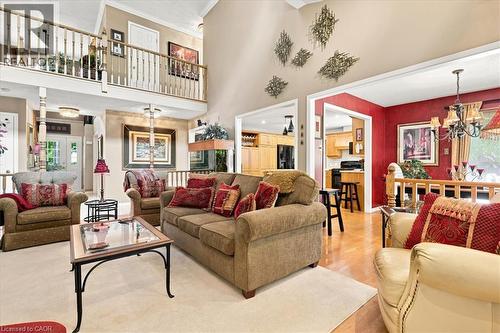 Two-story living area with an upper-level balcony featuring white spindle railings - 39 Everwood Run, Kitchener, ON - Indoor Photo Showing Living Room