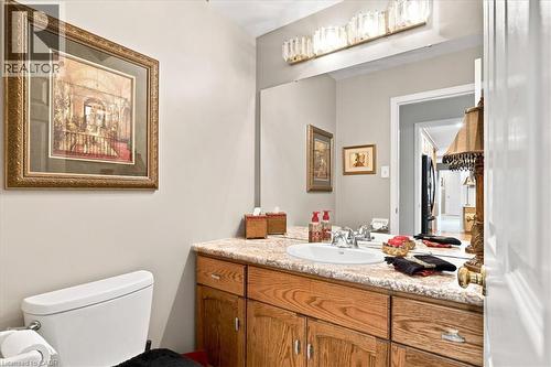 Bathroom featuring a vanity with a light-colored countertop, an undermount sink, and wood-finish cabinetry - 39 Everwood Run, Kitchener, ON - Indoor Photo Showing Bathroom