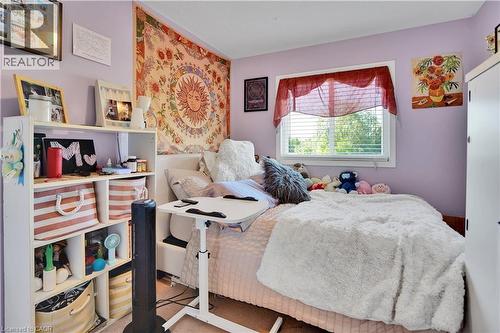 Light purple interior walls featuring a white-framed window with blinds - 60 Featherstone Street, Kitchener, ON - Indoor Photo Showing Bedroom