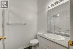 Bathroom vanity with an integrated sink, a large wall-mounted mirror, and a three-light fixture - 