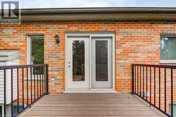 Outdoor deck with composite wood-look decking and black metal railings - 