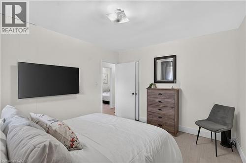 Interior room featuring light-toned walls, wood-finish flooring, and a flush-mount ceiling light fixture - 236 Hammersmith Court, Burlington, ON - Indoor Photo Showing Bedroom