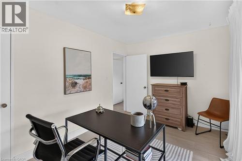 Interior room featuring light-toned walls, wood-finish flooring, and a white door with a round knob - 236 Hammersmith Court, Burlington, ON - Indoor