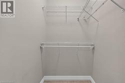Closet space featuring neutral wall paint, wire shelving, and a hanging rod - 