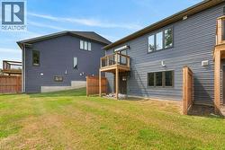 Expansive grass lawn bordered by wood fencing - 
