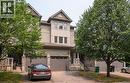 Multi-story townhouse facade featuring a gabled roofline, light-toned siding, and stone accents - 38 David Bergey Drive, Kitchener, ON  - Outdoor 