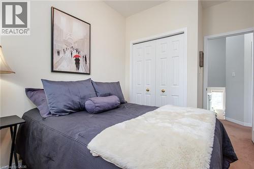 Bedroom featuring painted walls, carpet flooring, bi-fold closet doors, and recessed lighting in the hallway - 38 David Bergey Drive, Kitchener, ON - Indoor Photo Showing Bedroom