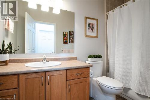 Bathroom featuring a wood-finish vanity with an integrated sink and laminate countertop - 38 David Bergey Drive, Kitchener, ON - Indoor Photo Showing Bathroom
