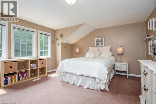 Spacious bedroom featuring multiple windows, a sloped ceiling detail, and built-in cube storage - 38 David Bergey Drive, Kitchener, ON - Indoor Photo Showing Bedroom