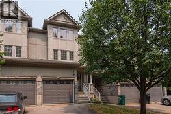 Two-story townhouse exterior with a stone and siding facade - 