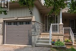 Exterior featuring light-colored vertical siding and stone veneer accents - 